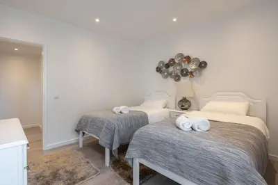 a room with two beds with towels on them at Piornais Apartment by Holiday Rental Madeira in Funchal