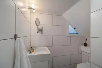 a white bathroom with a sink and a mirror at Eden Funchal by LovelyStay in Funchal