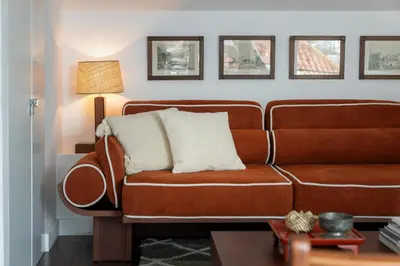 a living room with a brown couch with two pillows at Eden Funchal by LovelyStay in Funchal
