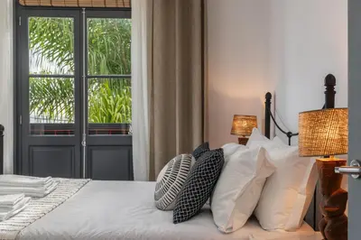 a bedroom with a bed with pillows and a window at Eden Funchal by LovelyStay in Funchal
