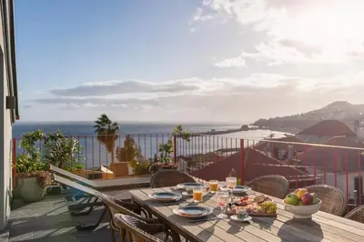 a table with food on top of a balcony at Eden Funchal by LovelyStay in Funchal