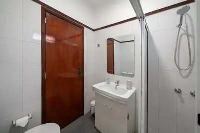 a bathroom with a toilet and a sink and a shower at Casa Imaculado Coração by An Island Apart in Funchal