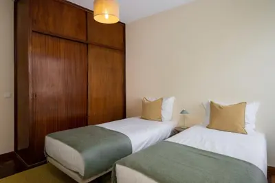 two beds sitting next to each other in a room at Casa Imaculado Coração by An Island Apart in Funchal