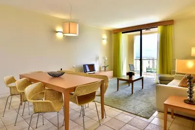 a swimming pool with lounge chairs and a swimming poolvisor at The Navigator - Colombus All Inclusive in Porto Santo