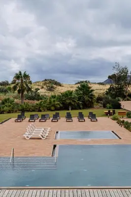 a building with a swimming pool in front of a building at The Navigator - Colombus All Inclusive in Porto Santo