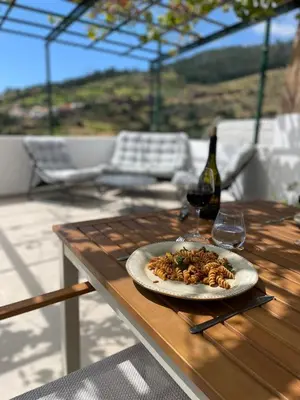 a plate of food on a table with a bottle of wine at Calheta Suite Vinha - Adults-only privé suite met hottub & zeezicht in Calheta