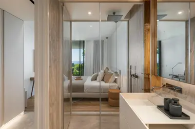 a bathroom with a sink and a bed in the background at Savoy Monumentalis IV by An Island Apart in Funchal