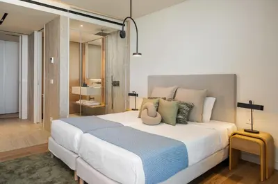 a bedroom with a large white bed with pillows at Savoy Monumentalis IV by An Island Apart in Funchal