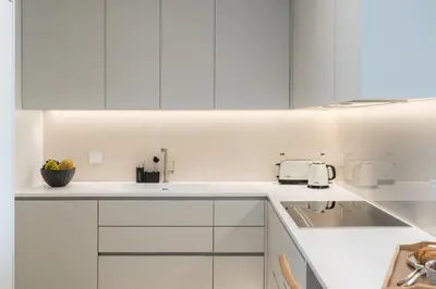 a white kitchen with white cabinets and a sink at Savoy Monumentalis IV by An Island Apart in Funchal