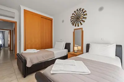 a hotel room with two beds and a mirror at Coastal Terrace Apartment in Lagos