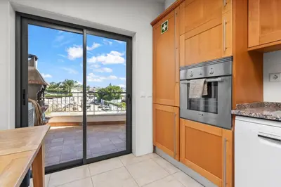 a kitchen with a view of a balcony at Coastal Terrace Apartment in Lagos