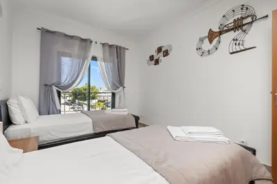 a bedroom with two beds and a window with a view at Coastal Terrace Apartment in Lagos
