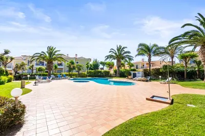 a swimming pool in a yard with palm trees at Coastal Charm Apartment in Lagos