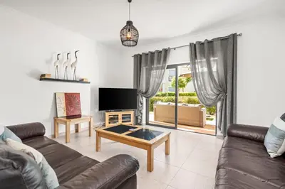 a living room with a couch and a table at Coastal Charm Apartment in Lagos