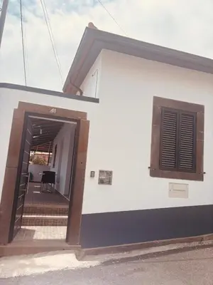 a white building with a door and a window at Vila Ramos I in Funchal