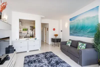 a living room with a couch and a kitchen at Blue Horizon Apartment in Luz