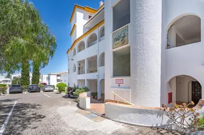 an apartment building with a parking lot at Blue Horizon Apartment in Luz