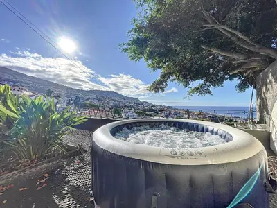 a large tub filled with water sitting next to the ocean at Villa Santa Luzia 2 by Atlantic Holiday in Santa Luzia