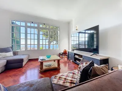 a living room with a couch and a tv at Villa Santa Luzia 2 by Atlantic Holiday in Santa Luzia