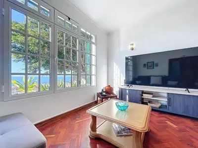 a living room with a table and a tv at Villa Santa Luzia 2 by Atlantic Holiday in Santa Luzia