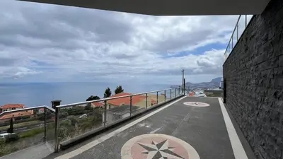 a balcony with a view of the ocean from a building at The View-Neves in Funchal