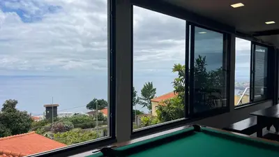 a room with windows looking out at the ocean at The View-Neves in Funchal