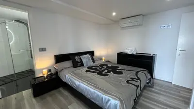 a bedroom with a bed and a glass shower at The View-Neves in Funchal
