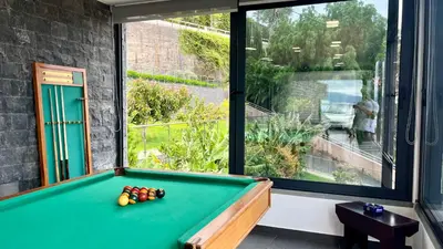 a pool table in a room with a large window at The View-Neves in Funchal