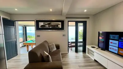 a living room with a couch and a flat screen tv at The View-Neves in Funchal