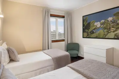 a hotel room with two beds and a window at Olimpo I by An Island Apart in Funchal