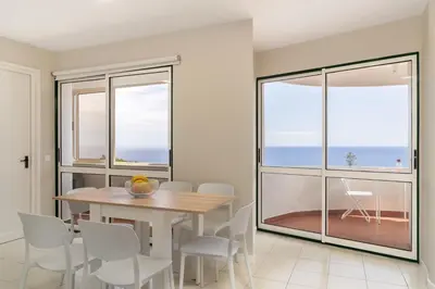 a dining room with a table and chairs at Olimpo I by An Island Apart in Funchal