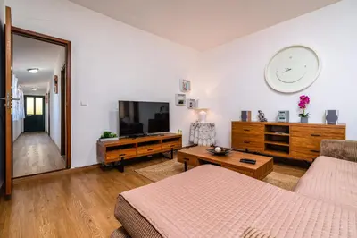 a living room with a flat screen tv and a coffee table at Casa Santos- Arco da Calheta in Arco da Calheta