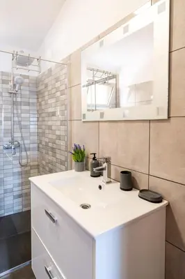 a bathroom with a white sink and a mirror at Casa Santos- Arco da Calheta in Arco da Calheta