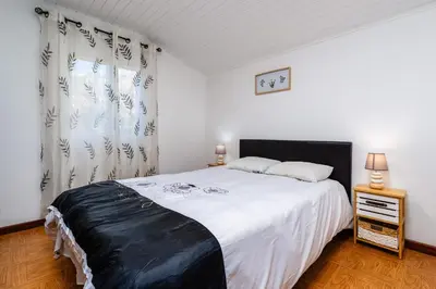 a bedroom with a large bed with a black headboard at Casa Santos- Arco da Calheta in Arco da Calheta