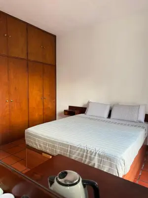 a bedroom with a bed and a wooden cabinet at Beautiful Room in the montains in Estrela