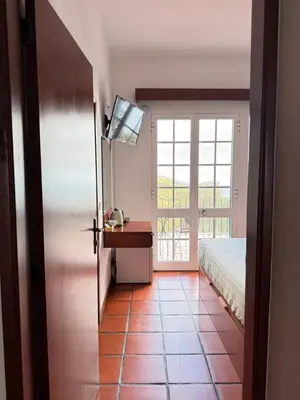 a bedroom with a bed and a desk and a window at Beautiful Room in the montains in Estrela