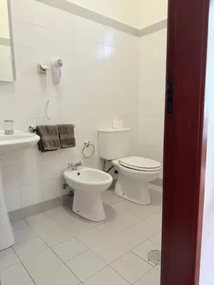 a white bathroom with a toilet and a sink at Beautiful Room in the montains in Estrela