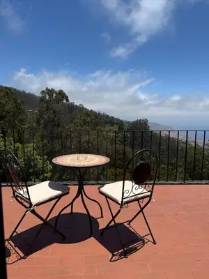 a table and two chairs sitting on a patio at Beautiful Room in the montains in Estrela