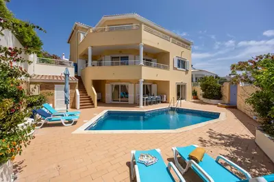 a villa with a swimming pool and a house at Villa Oceana in Luz