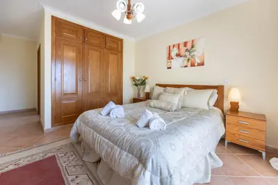 a bedroom with a large bed with towels on it at Villa Oceana in Luz