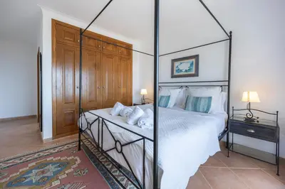 a bedroom with a four poster bed with a canopy at Villa Oceana in Luz