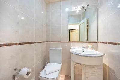 a bathroom with a toilet and a sink and a mirror at Villa Oceana in Luz