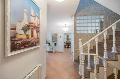 a staircase in a home with a painting on the wall at Villa Oceana in Luz
