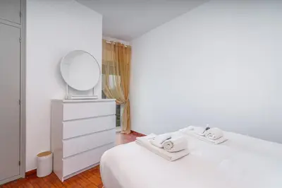 a white bedroom with a white bed and a mirror at Retreat with sea view #1973 in Budens
