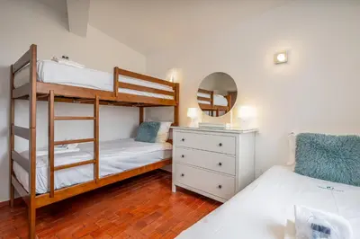 a bedroom with two bunk beds and a dresser at Retreat with sea view #1973 in Budens