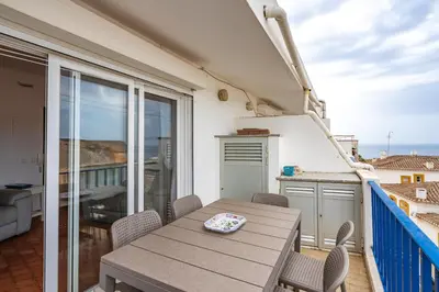 a patio with a table and chairs on a balcony at Retreat with sea view #1973 in Budens