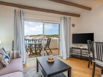 a living room with a couch and a large window at Retreat with sea view #1972 in Budens