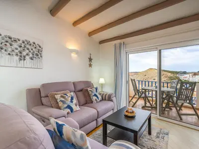 a living room with a couch and a table at Retreat with sea view #1972 in Budens