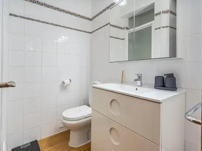 a white bathroom with a toilet and a sink at Retreat with sea view #1972 in Budens