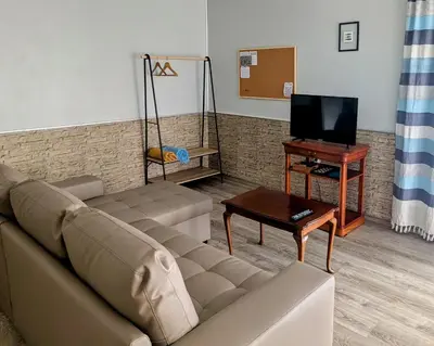 a living room with a couch and a table at Adega Studio in Machico